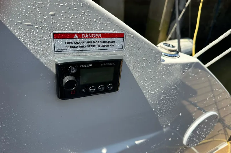 Slide: The Image of Control panel on 2022 Sea Ray SLX 250 boat, with warning label and water droplets. - 48