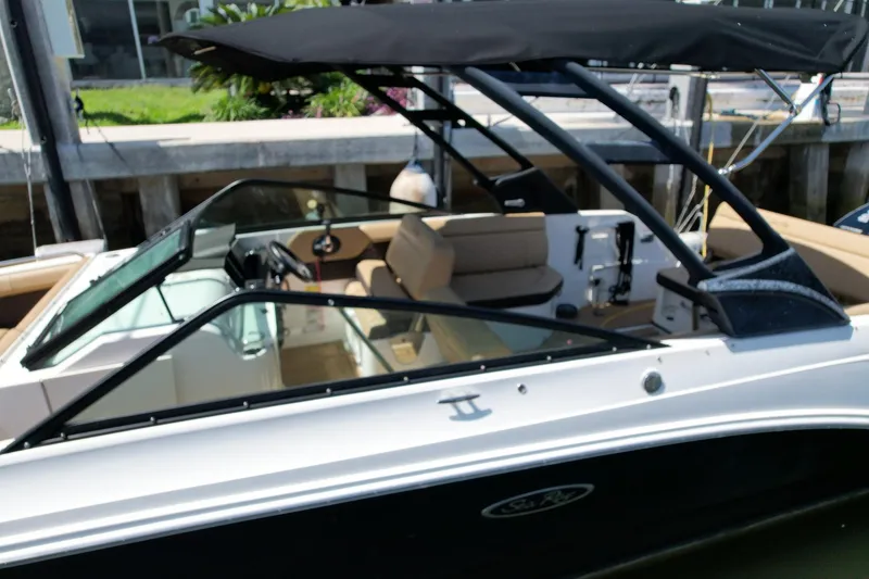 Slide: The Image of 2022 Sea Ray SLX 250 boat docked, featuring sleek design and spacious seating. - 13