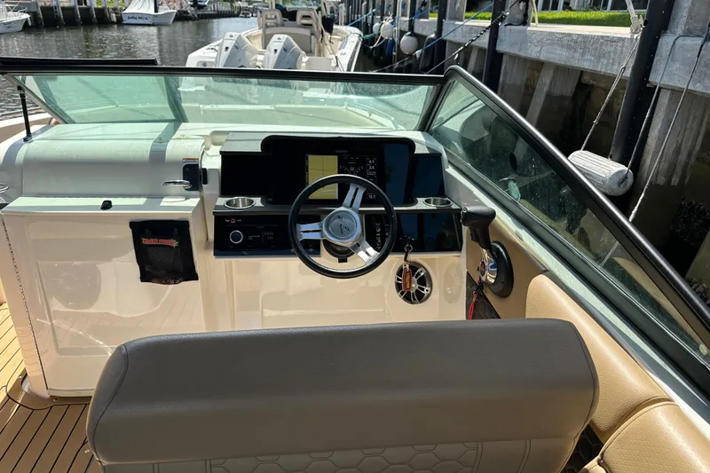 Slide: The Image of 2022 Sea Ray SLX 250 boat cockpit with steering wheel and control panel. - 15