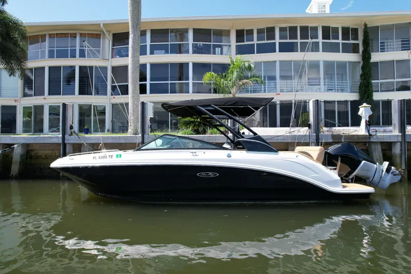 Slide: The Image of 2022 Sea Ray SLX 250 boat docked by waterfront building. - 1