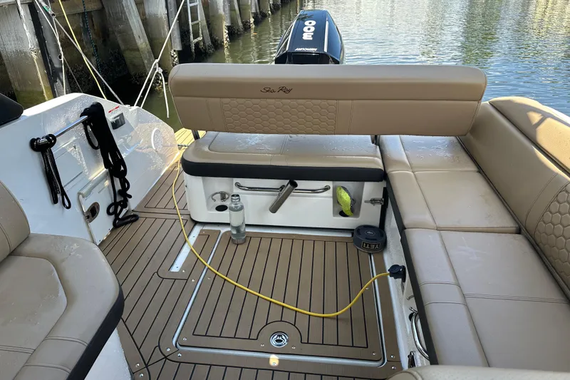 Slide: The Image of Interior view of 2022 Sea Ray SLX 250 boat with tan seating and teak flooring. - 23