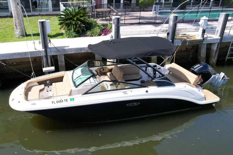 Slide: The Image of 2022 Sea Ray SLX 250 boat docked, featuring sleek design and spacious seating. - 50