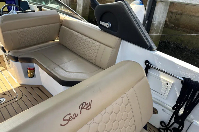 Slide: The Image of Luxurious interior of 2022 Sea Ray SLX 250 boat with beige seating and wood accents. - 41
