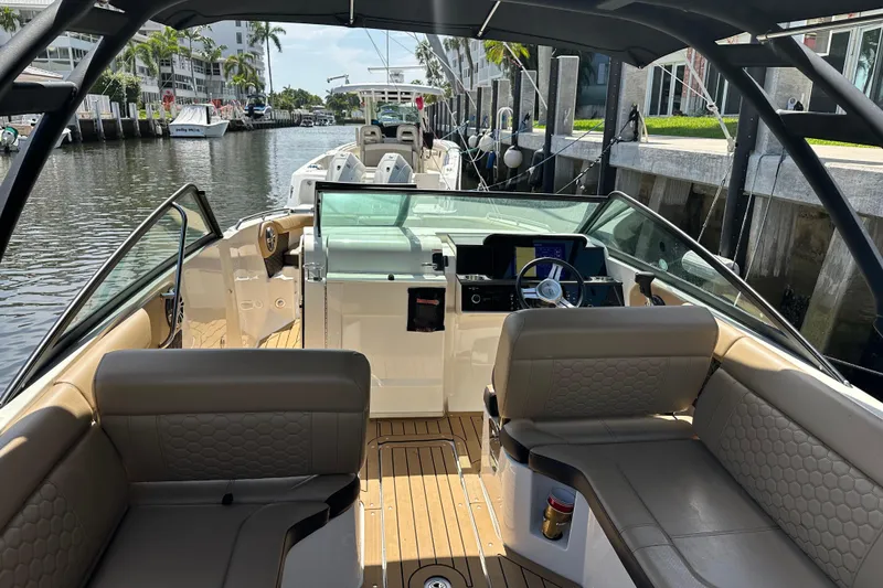 Slide: The Image of 2022 Sea Ray SLX 250 boat interior with luxurious seating and modern dashboard. - 14