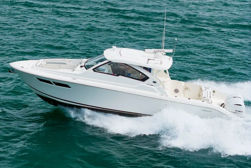 Slide: The Image of A 2021 Pursuit DC 365 Dual Console boat speeds across the sea, surrounded by splashing water. - 4
