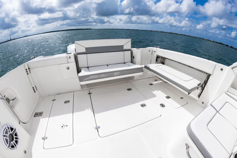 Slide: The Image of The image shows the spacious aft deck of a 2021 Pursuit DC 365 Dual Console boat. - 11