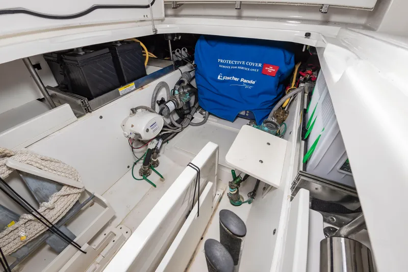 Slide: The Image of The storage area of a 2021 Pursuit DC 365 Dual Console boat with covers and equipment. - 22
