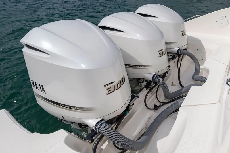 Slide: The Image of Three Yamaha 300 outboard engines are mounted on the stern of a Pursuit DC 365 Dual Console boat. - 16