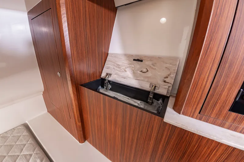 Slide: The Image of Interior of a 2021 Pursuit DC 365 Dual Console with wood paneling and storage space. - 42