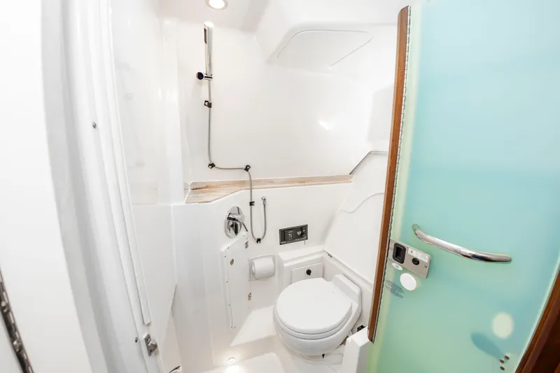 Slide: The Image of The image shows a modern boat bathroom with a toilet and shower. - 47