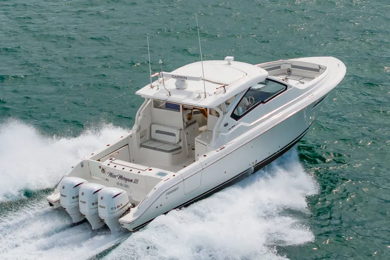 Slide: The Image of A white 2021 Pursuit DC 365 Dual Console boat speeding across the water. - 1