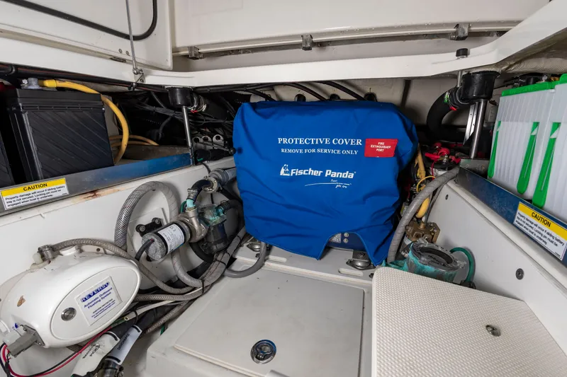 Slide: The Image of The engine compartment of a 2021 Pursuit DC 365 Dual Console with a Fischer Panda generator. - 23