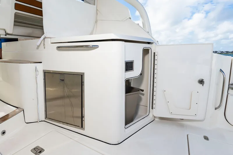 Slide: The Image of The 2021 Pursuit DC 365 Dual Console features a white onboard kitchen with stainless steel accents. - 20