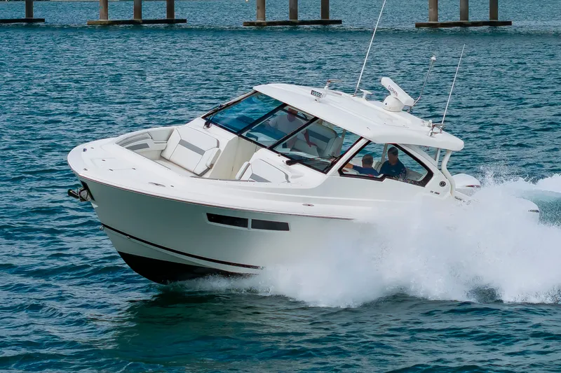 Slide: The Image of A white boat speeding across the water, featuring a covered cabin and multiple seating areas. - 2