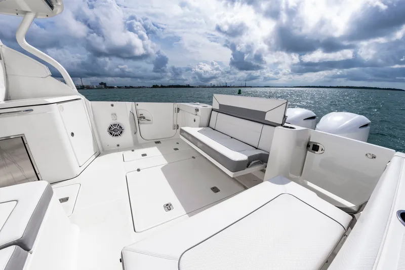 Slide: The Image of The image shows the spacious aft deck of a 2021 Pursuit DC 365 Dual Console boat with seating. - 13