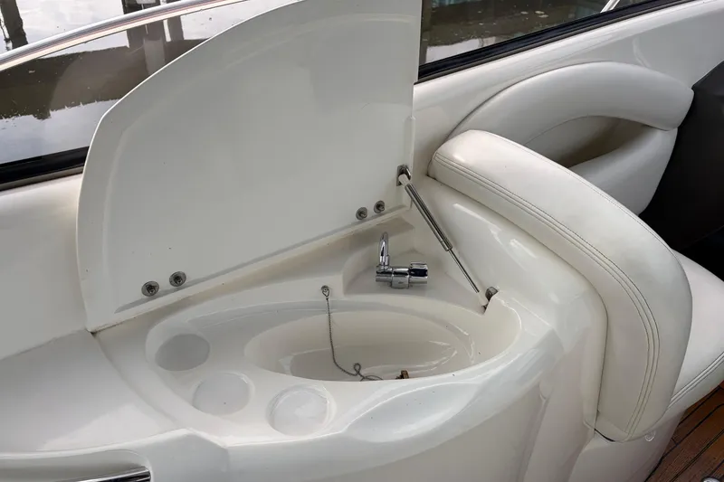 Slide: The Image of Interior sink area of a 2000 Sunseeker Superhawk 34 yacht, featuring sleek white design. - 12