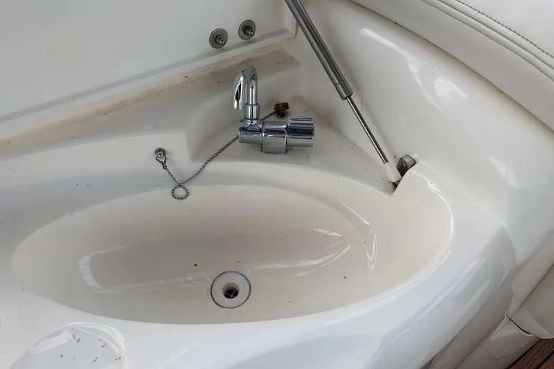 Slide: The Image of Sunseeker Superhawk 34 (2000) yacht sink with chrome faucet and hydraulic support. - 13