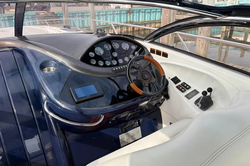 Slide: The Image of Cockpit of 2000 Sunseeker Superhawk 34 with steering wheel and control panel. - 17