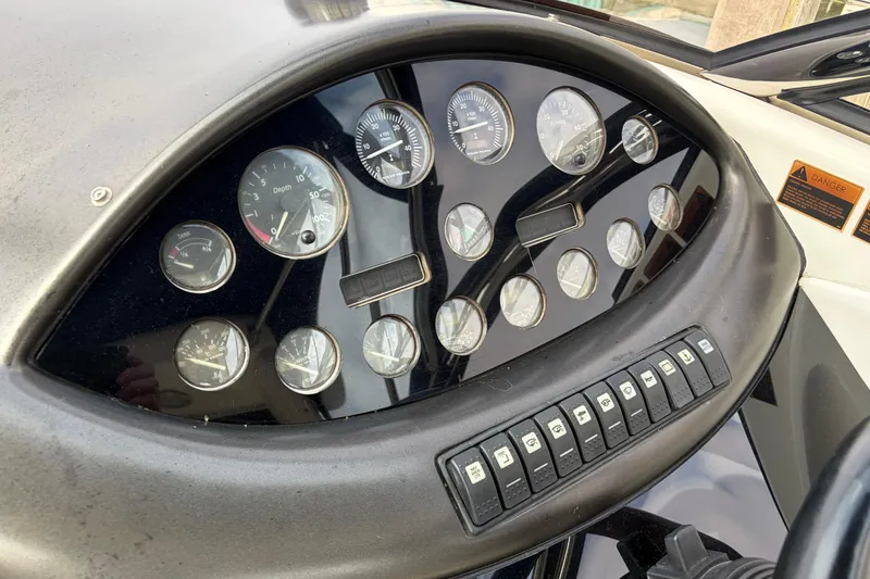 Slide: The Image of Dashboard of a 2000 Sunseeker Superhawk 34, featuring gauges and control switches. - 18
