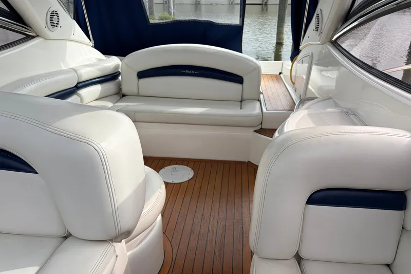 Slide: The Image of Luxurious interior of 2000 Sunseeker Superhawk 34 yacht with white leather seating and wood flooring. - 21