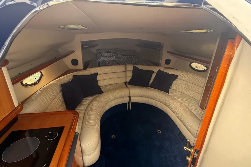 Slide: The Image of Luxurious interior of 2000 Sunseeker Superhawk 34 yacht with curved seating and cushions. - 24