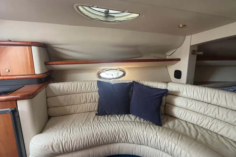 Slide: The Image of Interior of 2000 Sunseeker Superhawk 34 yacht with cream leather seating and blue cushions. - 26