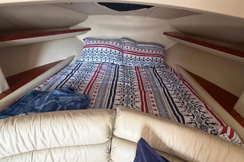 Slide: The Image of Cozy cabin interior of 2000 Sunseeker Superhawk 34 with nautical-themed bedding. - 27