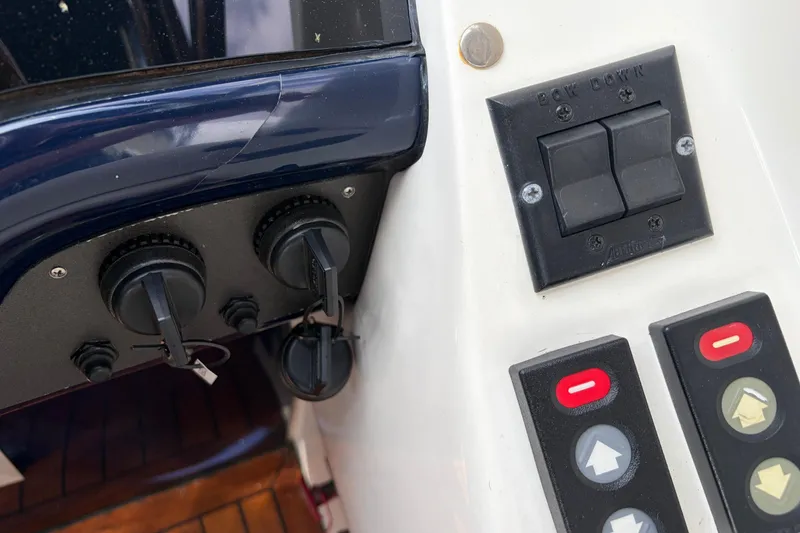 Slide: The Image of Control panel of a 2000 Sunseeker Superhawk 34 yacht with switches and dials. - 28