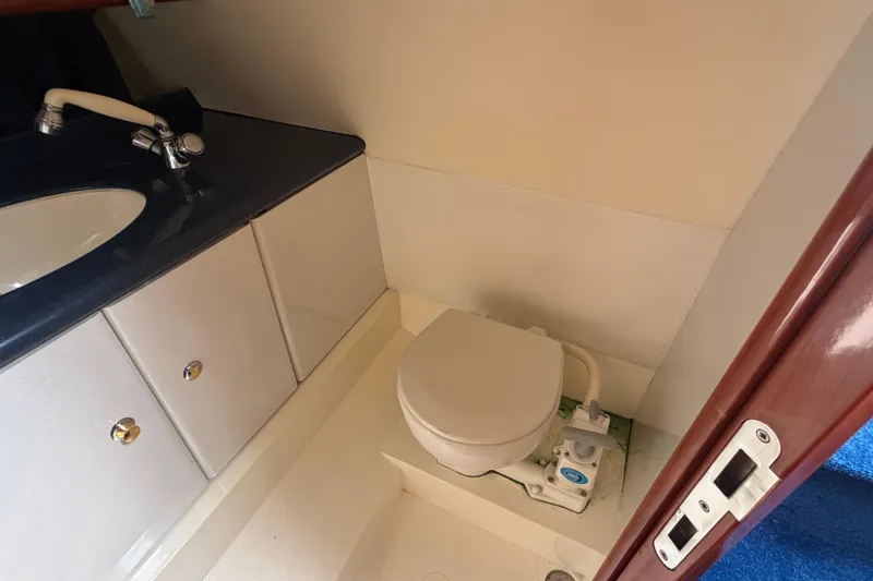 Slide: The Image of Bathroom interior of 2000 Sunseeker Superhawk 34 yacht, featuring toilet and sink. - 30