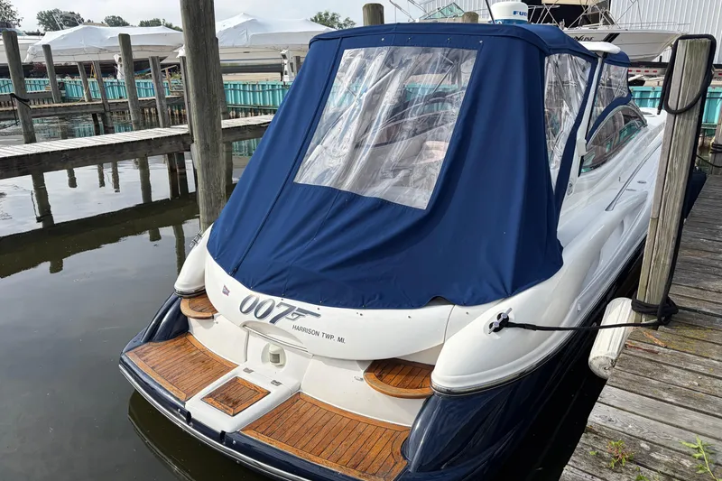 Slide: The Image of Sunseeker Superhawk 34 yacht, 2000 model, docked with blue cover in marina. - 4