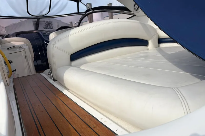 Slide: The Image of Sunseeker Superhawk 34 (2000) interior with white leather seating and wooden flooring. - 7