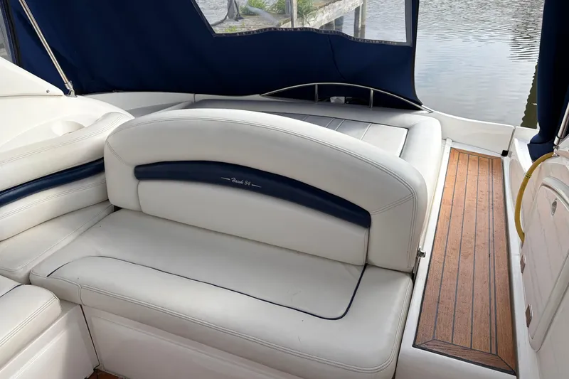Slide: The Image of Sunseeker Superhawk 34 yacht interior, featuring white leather seating and wooden flooring, 2000 model. - 8