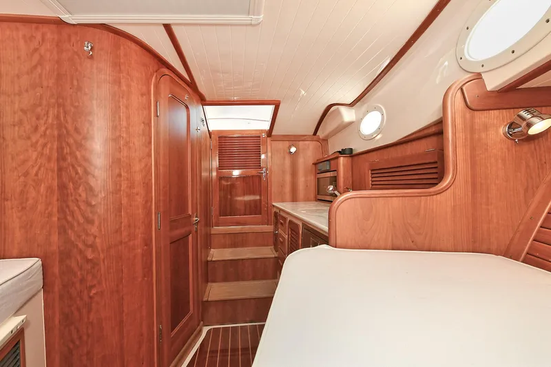Slide: The Image of Interior of 2015 Hinckley Talaria 34 yacht with elegant wood finish and cozy cabin. - 25