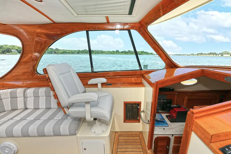 Slide: The Image of Interior of 2015 Hinckley Talaria 34 yacht with elegant wood finish and scenic water view. - 11