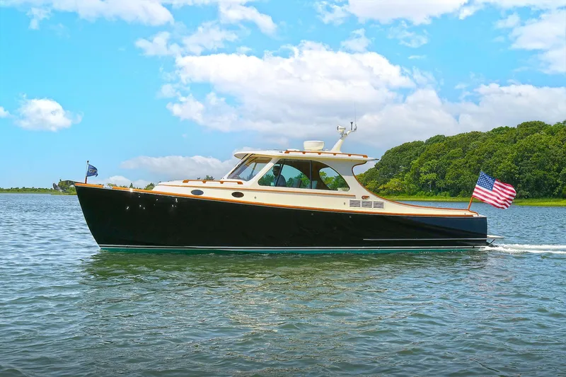 Slide: The Image of 2015 Hinckley Talaria 34 yacht cruising on a sunny day with American flag. - 27
