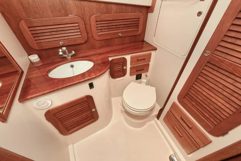 Slide: The Image of Luxurious 2015 Hinckley Talaria 34 yacht bathroom with wooden cabinetry and modern fixtures. - 26