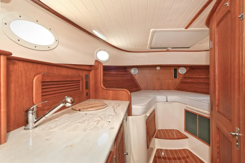 Slide: The Image of Luxurious 2015 Hinckley Talaria 34 yacht interior with elegant wood finish and cozy seating area. - 22