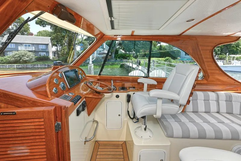 Slide: The Image of Interior of 2015 Hinckley Talaria 34 yacht with elegant wood finish and modern controls. - 8
