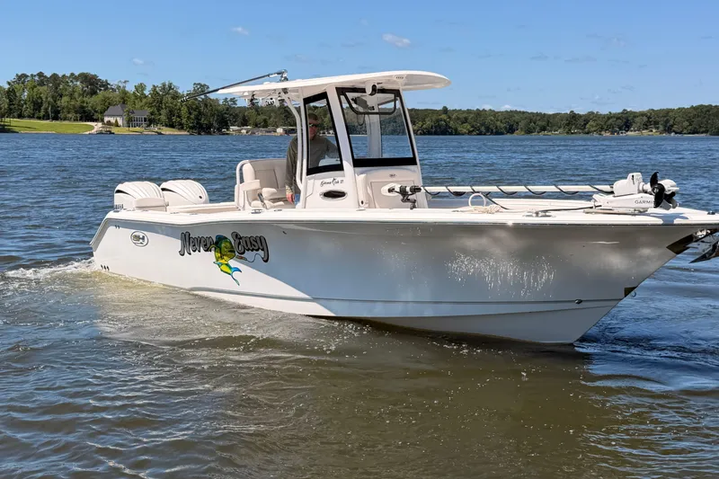 The Image of 2024 Sea Hunt Gamefish 27 Coffin Box boat cruising on a scenic lake. - 0