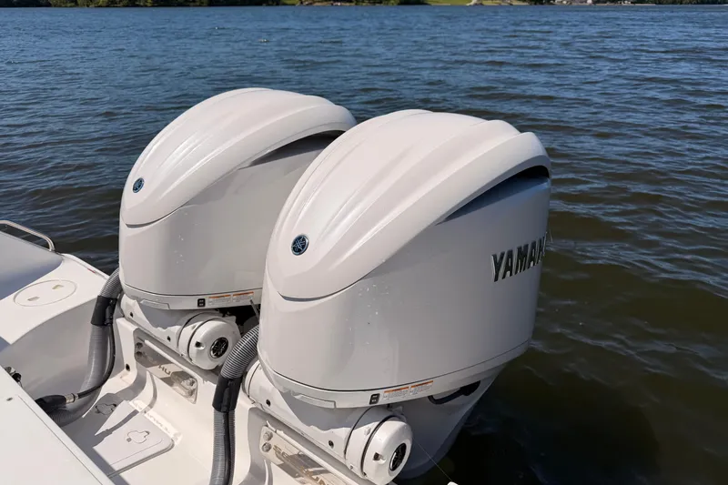 Slide: The Image of 2024 Sea Hunt Gamefish 27 Coffin Box with dual Yamaha outboard motors on water. - 10