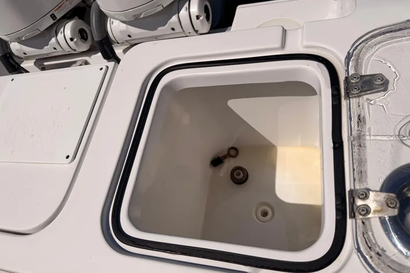 Slide: The Image of 2024 Sea Hunt Gamefish 27 Coffin Box interior, showcasing storage compartment details. - 18