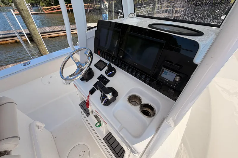 Slide: The Image of 2024 Sea Hunt Gamefish 27 Coffin Box helm with advanced controls and navigation displays. - 22