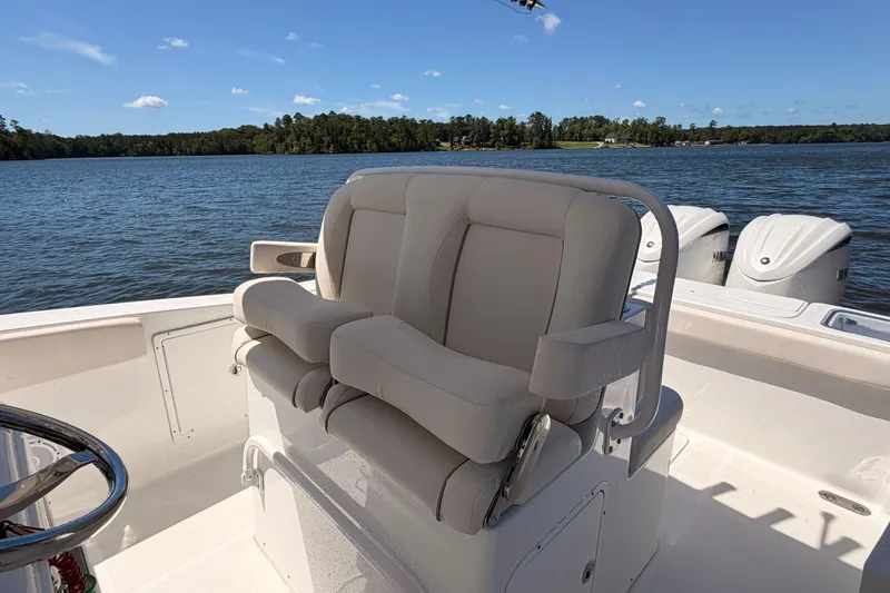 Slide: The Image of 2024 Sea Hunt Gamefish 27 Coffin Box boat interior with comfortable seating and scenic water view. - 23