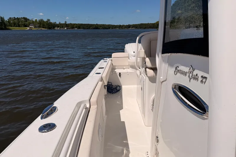 Slide: The Image of 2024 Sea Hunt Gamefish 27 Coffin Box boat on calm water, side view. - 24