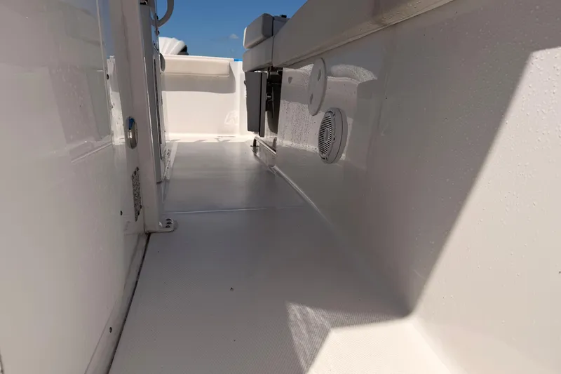 Slide: The Image of 2024 Sea Hunt Gamefish 27 Coffin Box interior, showcasing sleek white deck and modern design. - 25