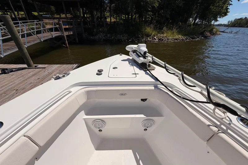 Slide: The Image of 2024 Sea Hunt Gamefish 27 Coffin Box boat docked by a serene lakeside. - 28