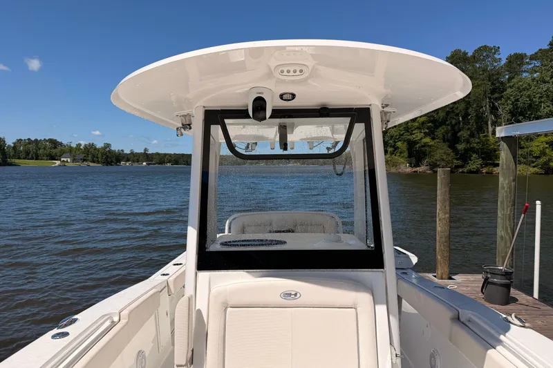 Slide: The Image of 2024 Sea Hunt Gamefish 27 Coffin Box boat docked on a sunny lake. - 29
