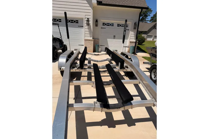 Slide: The Image of Boat trailer for 2024 Sea Hunt Gamefish 27 Coffin Box, parked in driveway. - 30