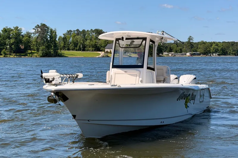Slide: The Image of 2024 Sea Hunt Gamefish 27 Coffin Box boat on a scenic lake. - 4