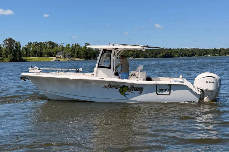 Slide: The Image of 2024 Sea Hunt Gamefish 27 Coffin Box boat on a serene lake. - 8